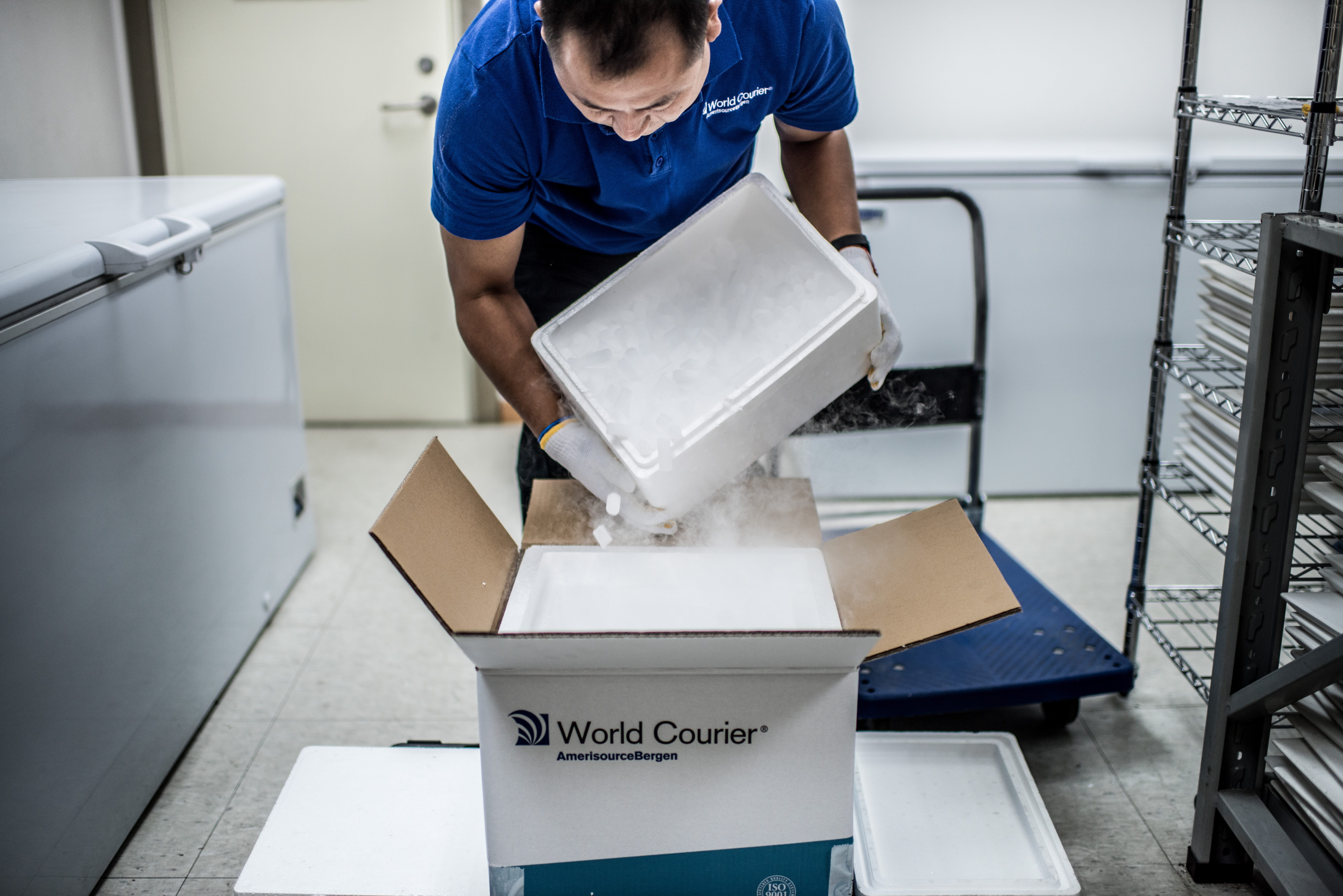 A man opens a dry ice shipper.