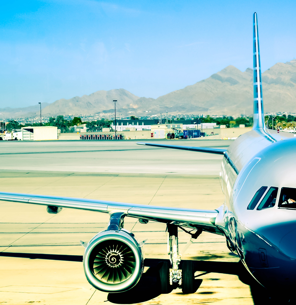 A closeup view of a jet plane sitting at a gate, ready to be loaded.